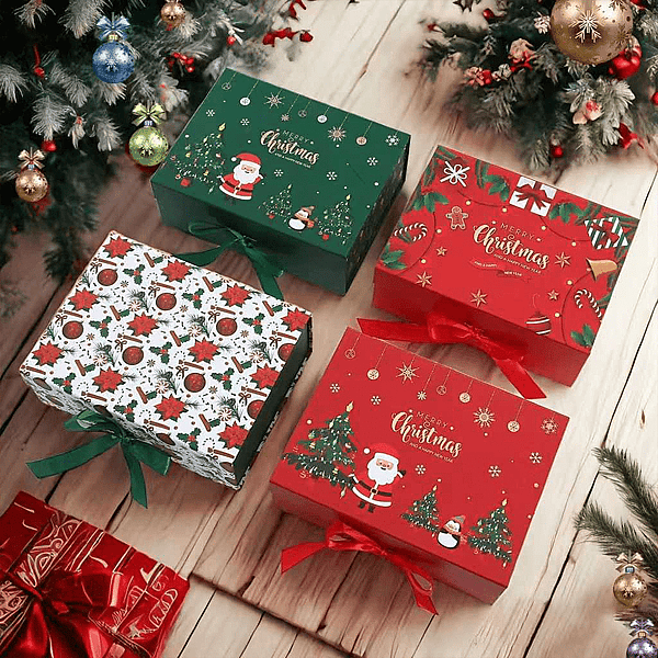 Colorful Christmas gift boxes with festive designs, including Santa Claus and evergreen trees, sit on a wooden floor under a decorated Christmas tree, each wrapped with red or green ribbons.